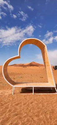 a bench in the middle of the desert at Mountain luxury camps in Merzouga