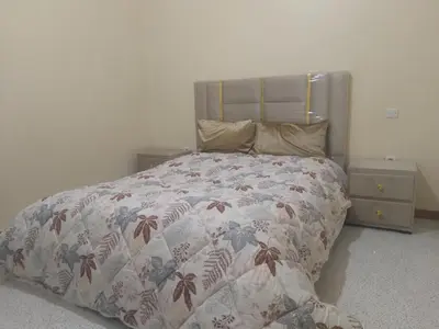 a bedroom with a bed with a quilt on it at شقة للكراء اليومي بمركز تنغير in Tinerhir