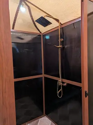 a shower in a room with a ceiling at Desert Nights Camp in Merzouga