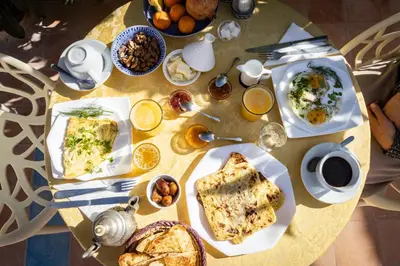 a table with plates of food on top of it at Ksar Sania - Merzouga in Merzouga