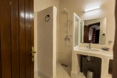 a bathroom with a sink and a mirror at Ksar Sania - Merzouga in Merzouga