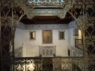 an ornate iron gate in a building with a balcony at Rooms in Dar Drouj, a special 14th century house Riad in Fès