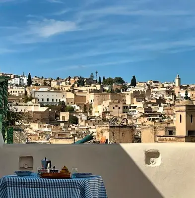 a table with a view of a city at Rooms in Dar Drouj, a special 14th century house Riad in Fès