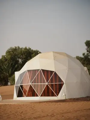 a large white dome building in the desert at Sahara Bubble in Merzouga
