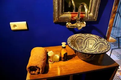 a bathroom with a sink and a towel and a mirror at Sahara Bubble in Merzouga