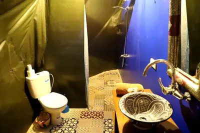 a bathroom with a toilet and a sink at Sahara Bubble in Merzouga