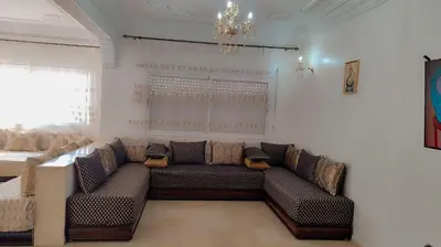 a living room with a couch and a window at Appartement 3 chambre et deux salon pour les familles in Fès