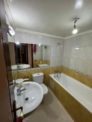 a bathroom with a sink and a toilet and a tub at Appartement 3 chambre et deux salon pour les familles in Fès