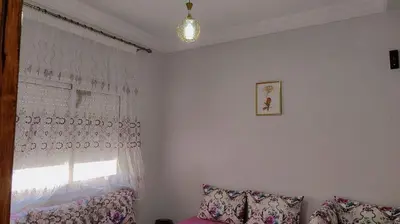 a living room with a window and a couch at Appartement 3 chambre et deux salon pour les familles in Fès