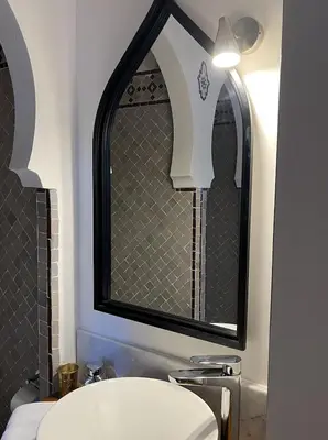 a bathroom with a sink and a mirror at Riad Hanael Garden & Spa in Fès
