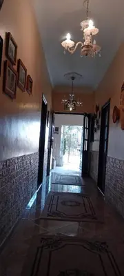a hallway of a house with a door and a chandelier at Dar Fouzia in Bothmat