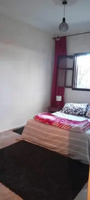 a bedroom with a bed and a window at Dar Fouzia in Bothmat