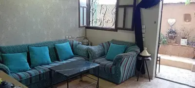a living room with a couch and two chairs at Dar Fouzia in Bothmat