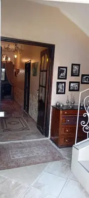 a room with an open door to a room with a dresser at Dar Fouzia in Bothmat