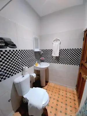 a bathroom with a white toilet and a sink at Dar Abdellah in Fès
