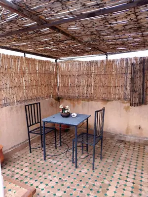 a blue table and two chairs in a room at Dar Abdellah in Fès