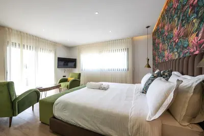 a bedroom with a large bed with a painting on the wall at Villa Safira, Haut-Standing avec piscine & Hammam in Marrakech