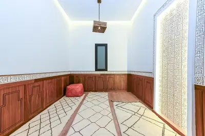 an empty room with a red chair and a window at Villa Safira, Haut-Standing avec piscine & Hammam in Marrakech