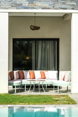 a couch sitting on a patio next to a pool at Villa Safira, Haut-Standing avec piscine & Hammam in Marrakech