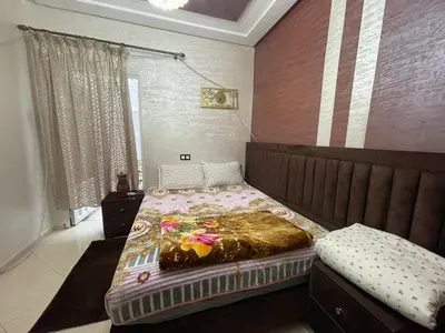 a bedroom with a bed with a bedspread on it at Mchimicha in Fès