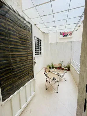a balcony with a table and a large window at Mchimicha in Fès
