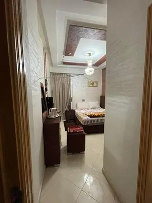 a hallway leading to a bedroom with a bed at Mchimicha in Fès