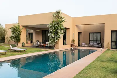 a house with a swimming pool in the yard at Villa A Atlas Retreat Luxury B and B Beni Mellal in Beni Mellal