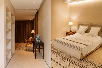 a bedroom with a bed and a room with a desk at Villa A Atlas Retreat Luxury B and B Beni Mellal in Beni Mellal