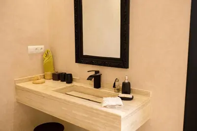 a bathroom with a sink and a mirror at Villa A Atlas Retreat Luxury B and B Beni Mellal in Beni Mellal