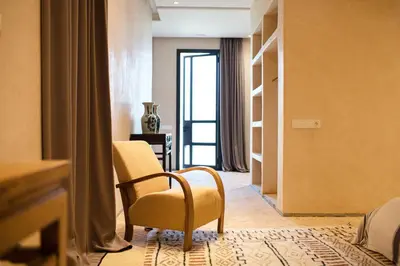 a room with a chair and a room with a window at Villa A Atlas Retreat Luxury B and B Beni Mellal in Beni Mellal