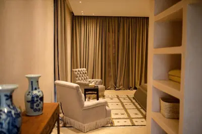 a living room with two chairs and a table at Villa A Atlas Retreat Luxury B and B Beni Mellal in Beni Mellal