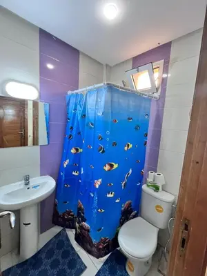 a bathroom with a shower curtain with a fish on it at Charming Two Bedroom Apartment in Fes Near City Center in Fès