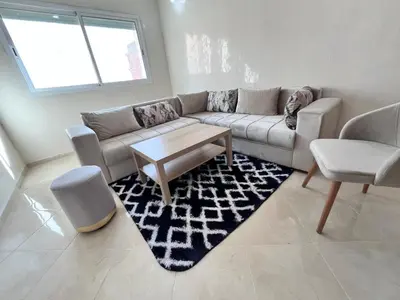a living room with a couch and a table at Charming Two Bedroom Apartment in Fes Near City Center in Fès