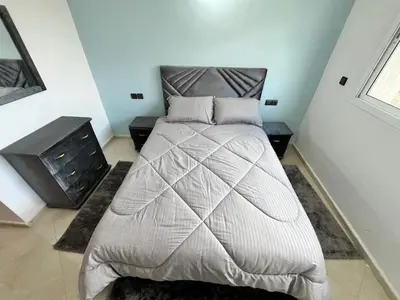 a bedroom with a bed and a fireplace in it at Charming Two Bedroom Apartment in Fes Near City Center in Fès