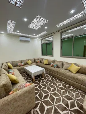 a living room with a couch and a table at Location amine in Azrou