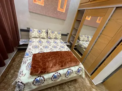 a bed in a room with two bunk beds at Location amine in Azrou
