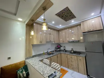 a kitchen with a sink and a refrigerator at Location amine in Azrou