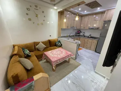 a living room with a couch and a table at Location amine in Azrou