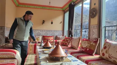 a man standing in front of a room filled with furniture at Dr ouanskra asni el haouz imlil in Imlil