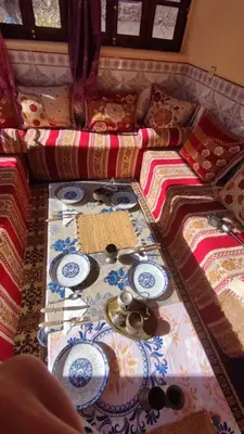 a couch with plates and dishes on top of it at Dr ouanskra asni el haouz imlil in Imlil