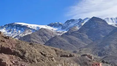 a view of a mountain range with snow covered mountains at Dr ouanskra asni el haouz imlil in Imlil