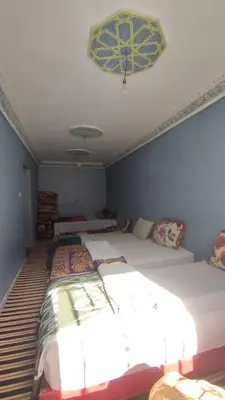 a bedroom with two beds and a ceiling at Dr ouanskra asni el haouz imlil in Imlil