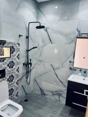 a bathroom with a shower and a toilet and a sink at Villa MK in Aghmat