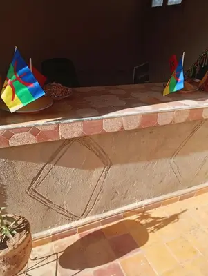 three kites sitting on top of a stone counter at Gite take your time takojt merzouga in Hassilabied