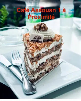 a slice of cake on a plate with a fork at Luxueux appartement Assouan centre-ville in Fès