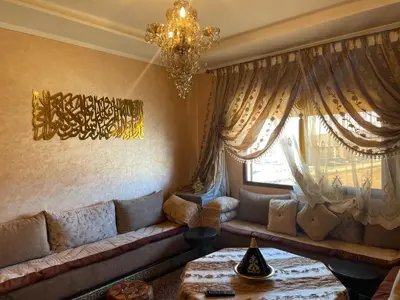 a living room with a couch and a chandelier at Appartement hind in Azrou