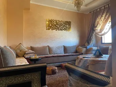 a living room with a couch and a table at Appartement hind in Azrou