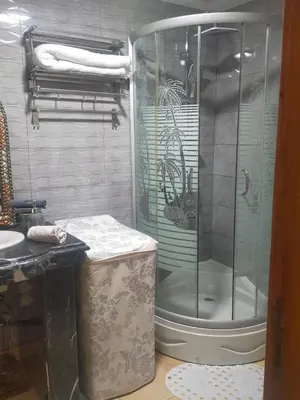 a shower with a glass door in a bathroom at Appartement hind in Azrou