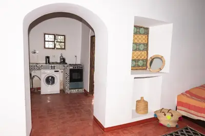 a kitchen with a washer and dryer in a room at Auberge Sremt in Sremt