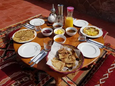 a wooden table with plates of food on it at Auberge Sremt in Sremt